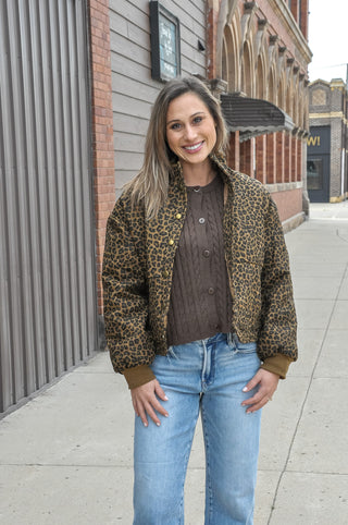 This brown leopard print quilted jacket brings bold pattern energy to a refined, structured silhouette.