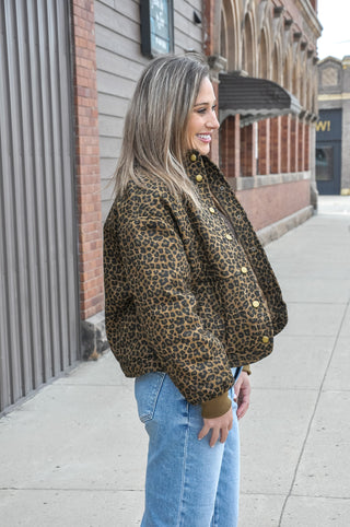 This brown leopard print quilted jacket brings bold pattern energy to a refined, structured silhouette.