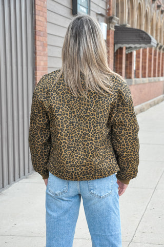 This brown leopard print quilted jacket brings bold pattern energy to a refined, structured silhouette.