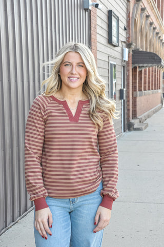 Contrast burgundy Y-split notch neckline with raglan sleeves.