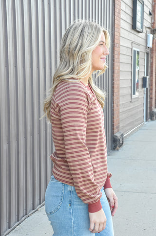 Contrast burgundy Y-split notch neckline with raglan sleeves.
