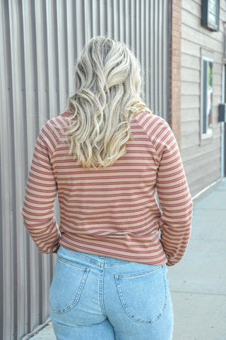 Contrast burgundy Y-split notch neckline with raglan sleeves.