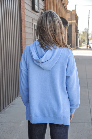 Available in black, blue, mauve, or denim, this ultra-soft hoodie features a relaxed silhouette that makes it an easy go-to piece for casual days, lounging, or layering through every season.