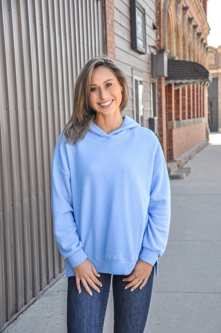 Available in black, blue, mauve, or denim, this ultra-soft hoodie features a relaxed silhouette that makes it an easy go-to piece for casual days, lounging, or layering through every season.