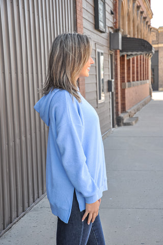 Available in black, blue, mauve, or denim, this ultra-soft hoodie features a relaxed silhouette that makes it an easy go-to piece for casual days, lounging, or layering through every season.