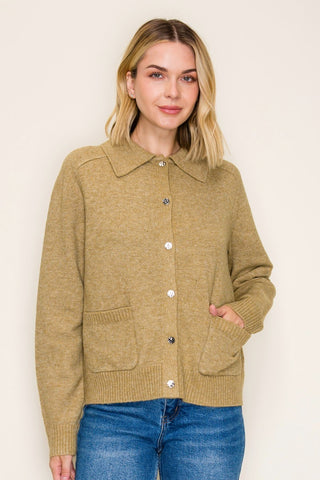 This collared button-down cardigan features a polished spread collar, side pockets, and a clean button-front closure that gives it a refined, put-together look — all while staying cozy and comfortable in a soft poly-wool blend.