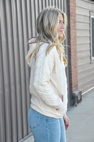 This quilted hoodie combines a half zip neckline with color-trimmed detail and dual pockets — a patch pocket and kangaroo pocket.
