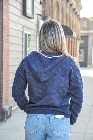This quilted hoodie combines a half zip neckline with color-trimmed detail and dual pockets — a patch pocket and kangaroo pocket.