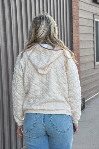 This quilted hoodie combines a half zip neckline with color-trimmed detail and dual pockets — a patch pocket and kangaroo pocket.
