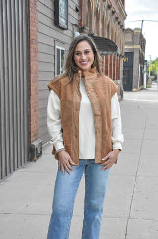 This cozy fleece vest features a soft, textured fabric with a clean minimal look that effortlessly elevates any outfit.