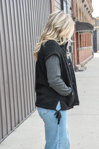 This cozy fleece vest features a soft, textured fabric with a clean minimal look that effortlessly elevates any outfit.