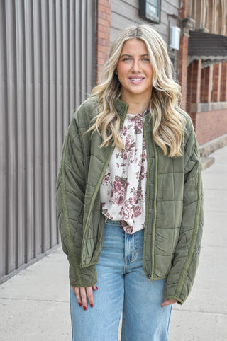 Featuring a quilted design, high neckline, and full-zip front, it offers a relaxed fit and ultra-soft 100% cotton fabric that's ideal for casual outings and cool-weather styling. Available in tan and olive.