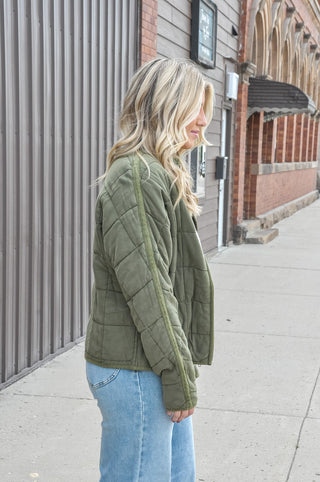 Featuring a quilted design, high neckline, and full-zip front, it offers a relaxed fit and ultra-soft 100% cotton fabric that's ideal for casual outings and cool-weather styling. Available in tan and olive.