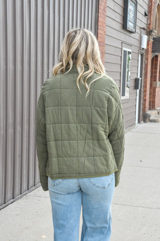 Featuring a quilted design, high neckline, and full-zip front, it offers a relaxed fit and ultra-soft 100% cotton fabric that's ideal for casual outings and cool-weather styling. Available in tan and olive.