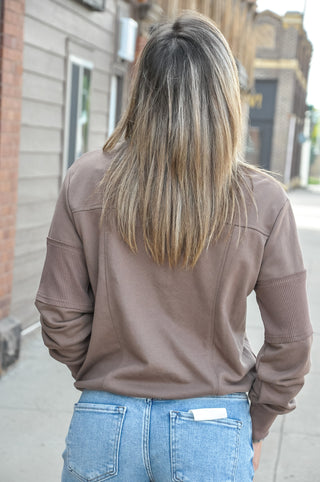 Crafted from 100% polyester, this pullover sweatshirt features a sleek half-zip front and a mock neckline for a touch of sporty sophistication.