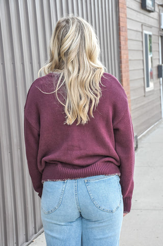 This crewneck cardigan is dressed up with delicate floral vine embroidery and charming contrast blanket stitch detailing.