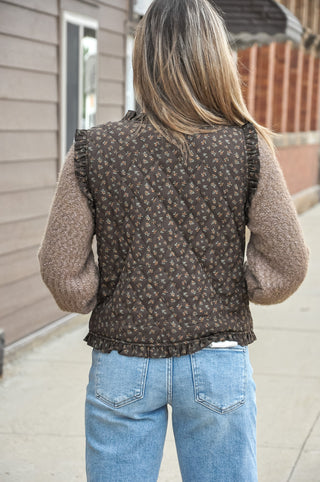 Brown sleeveless vest with a small floral pattern.