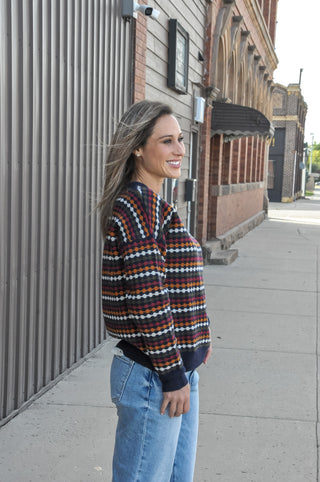 This navy crew neck sweater features a multicolor honeycomb texture stripe pattern.