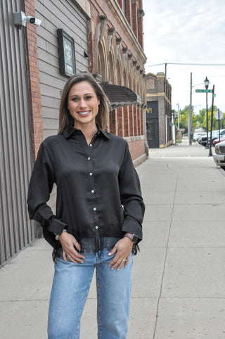 This satin loose fit shirt from Anniewear features a delicate lace hem detail that peeks out from under the silky fabric.