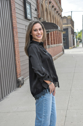 This satin loose fit shirt from Anniewear features a delicate lace hem detail that peeks out from under the silky fabric.