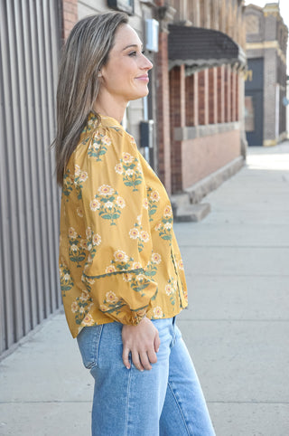 A split neckline with decorative contrast trim detail adds a thoughtful, feminine finish, while the long puff sleeves with elastic cuffs give it that effortlessly romantic, vintage-inspired feel.