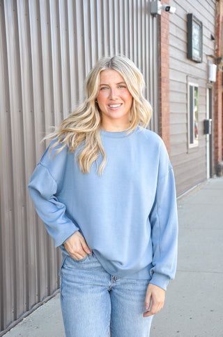 The classic crew neckline and long sleeves keep the silhouette clean and timeless, while the relaxed, oversized fit adds a laid-back, modern ease that works beautifully for both casual and elevated looks.
