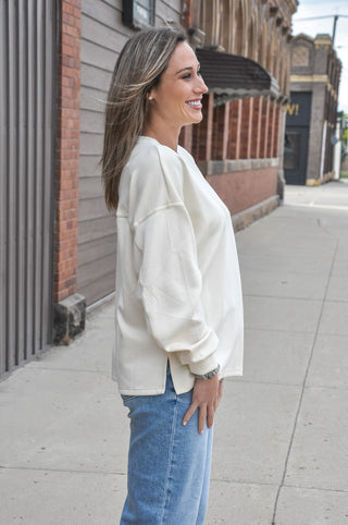 The classic crew neckline and long sleeves keep the silhouette clean and timeless, while the relaxed, oversized fit adds a laid-back, modern ease that works beautifully for both casual and elevated looks.