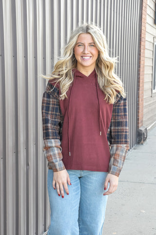 This micro brushed drawstring hoodie top is the perfect mix of cozy and cool, featuring plaid-inserted sleeves that give it that effortless mix-media charm.