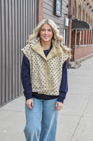  The textured sherpa fabric adds warmth and visual interest, while the playful polka dot pattern keeps it fun and fashion-forward. 