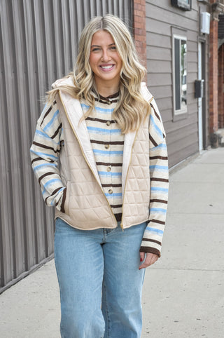 The full zip-up front makes layering effortless, while the attached hood adds an extra touch of warmth and laid-back style.