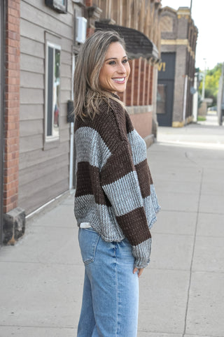 This staple stripe sweater features an airy knit with a rolled neckline and dropped shoulders for that effortless laidback look. 