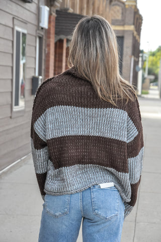 This staple stripe sweater features an airy knit with a rolled neckline and dropped shoulders for that effortless laidback look. 