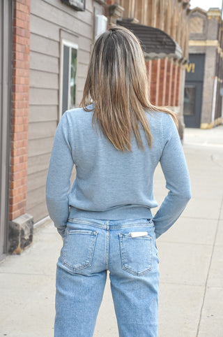 The classic crew neckline keeps the look polished and versatile, while the button-front design makes it easy to wear open or closed. 