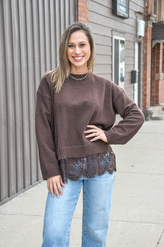 Soft-touch knit pairs with a scalloped hem and contrast floral lace trim for a feminine finish, while the loose fit keeps every layer easy and comfortable.