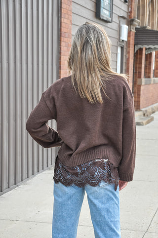 Soft-touch knit pairs with a scalloped hem and contrast floral lace trim for a feminine finish, while the loose fit keeps every layer easy and comfortable.
