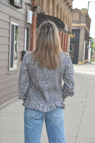 This long sleeve peplum top features a fully smocked bodice that hugs your curves in all the right places, a chic mock neck with delicate lettuce edging, and a flirty peplum hem that adds just the right amount of flair.
