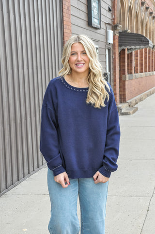 This stitch detailed solid sweater in a rich navy or beautiful plum, is one of those wardrobe-building pieces you'll reach for all season long.