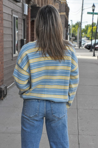 Pastel striped sweater cardigan crafted from cozy knit fabric. 