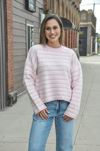 This relaxed striped knit sweater brings soft texture, a ribbed crew neckline, and a drop-shoulder fit that feels effortless with denim or trousers.