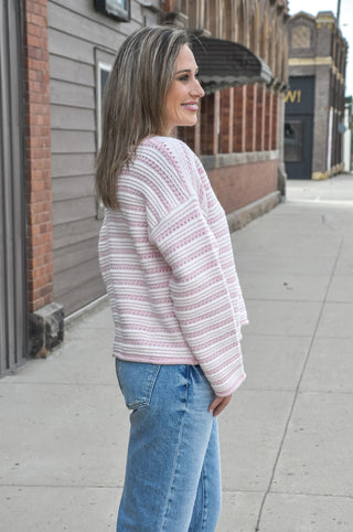 This relaxed striped knit sweater brings soft texture, a ribbed crew neckline, and a drop-shoulder fit that feels effortless with denim or trousers.