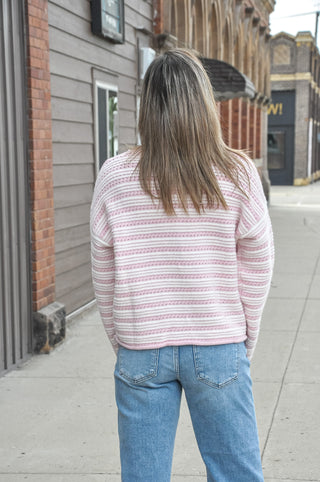 This relaxed striped knit sweater brings soft texture, a ribbed crew neckline, and a drop-shoulder fit that feels effortless with denim or trousers.