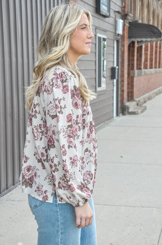 This taupe woven blouse features an allover vintage floral print with beautifully considered details that make it anything but ordinary.